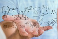 Eine Person hält eine Hand mit einer Zeichnung eines Geschäftssymbols, das Kreativität und Unternehmertum symbolisiert.