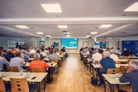 Group of people in front of a screen