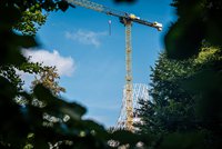 Construction crane in front of observation tower under construction