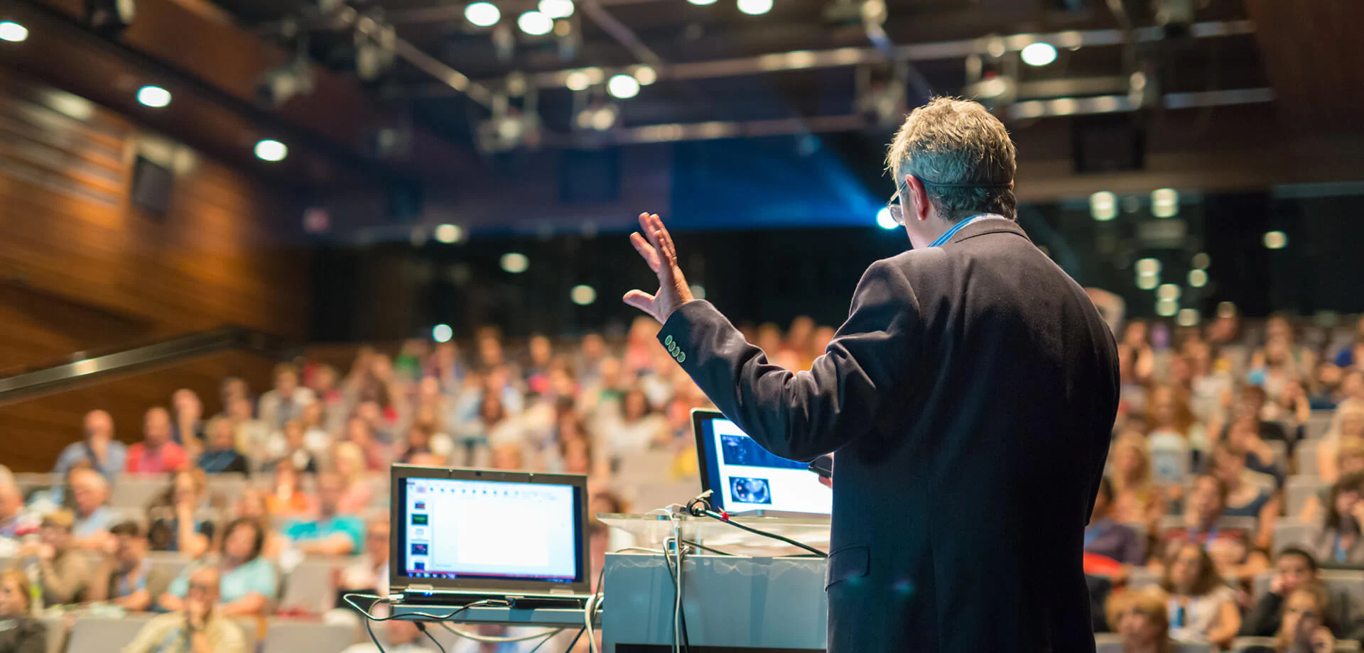 Veranstaltungen Bildbeschreibung / description: Ein Mann hält eine Präsentation auf einer Konferenz.